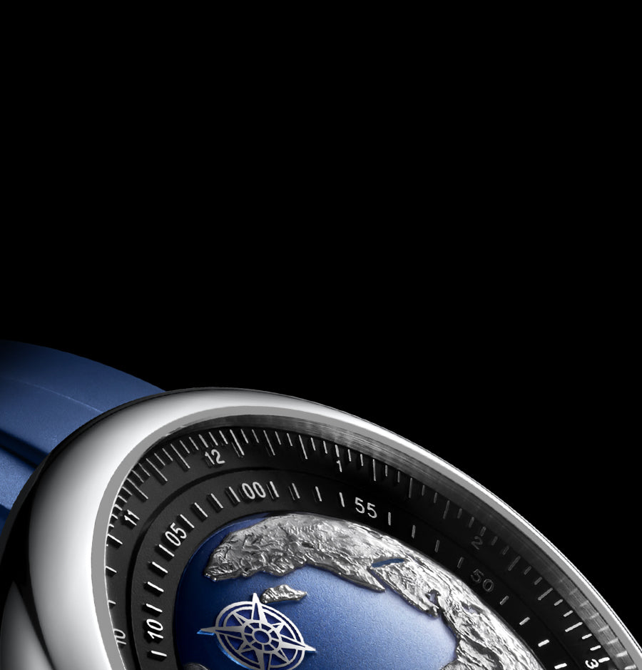 Top-down detail of the Blue Planet dial showing sculpted continents in silver against a deep blue ocean.